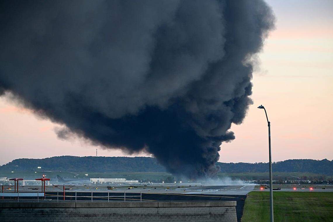 LOUISVILLE, KENTUCKY - NOVEMBER 04: Fire and smoke mark where a UPS cargo plane crashed near Louisville Muhammad Ali International Airport on November 04, 2025 in Louisville, Kentucky. The fully fueled plane crashed shortly after takeoff with a shelter-in-place order issued for within 5 miles of the airport. (Photo by Stephen Cohen/Getty Images)