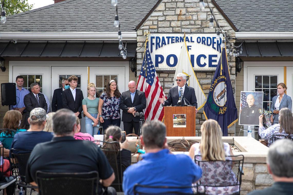 Former Lexington police chaplain Donovan Stewart, left of podium, with his family, listened as his lawyer, Scott Crosbie, talked Thursday about Stewart’s law enforcement career.