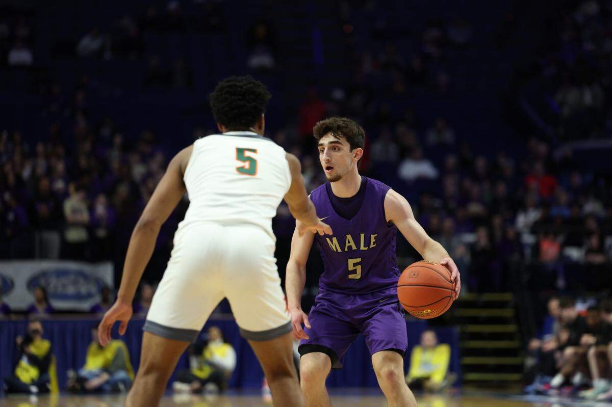 Jack Edelen of Male looked for options against Tylon Webb of Frederick Douglass on Friday night.