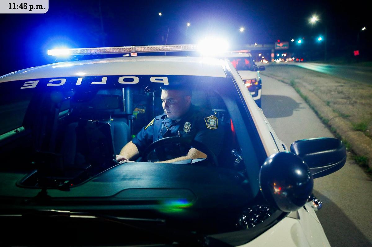 Lexington police officer Brian Hall writes a citation during a traffic stop on Richmond Road Friday, July 9. Hall, a graduate of Eastern Kentucky University, has has been a police officer with LPD for nearly five years. Hall works the third shift in Lexington’s east sector and patrols the area from Athens Boonsboro Road to Winchester Road. He enjoys the variety of the job in the east sector. “I like to say we do ten different jobs while we’re doing one job. We go to one call and it’s a theft report and then you go to another call and it’s a burglary in progress and then another one might be a mental illness, you just never know what pants you’re gonna have to put on when you get there,” he said.