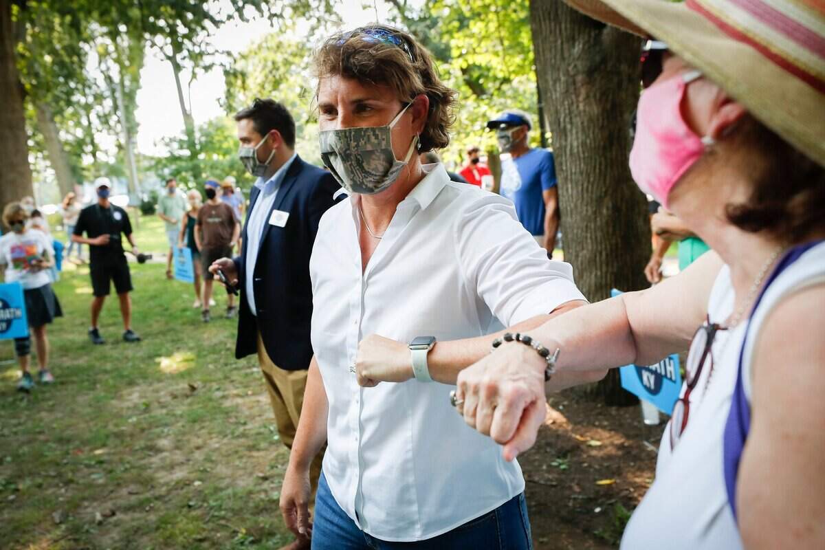 Democratic Kentucky Senate candidate Amy McGrath greets a supporter during a campaign stop at Woodland Park in Lexington, Ky., Tuesday, Aug. 25, 2020.
