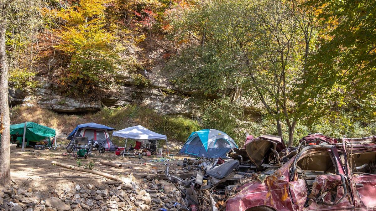 Flood debris is visible along Lower Caney Creek Road where a person was living in a tent on Tuesday, Oct. 11, 2022, in Breathitt County, Ky.