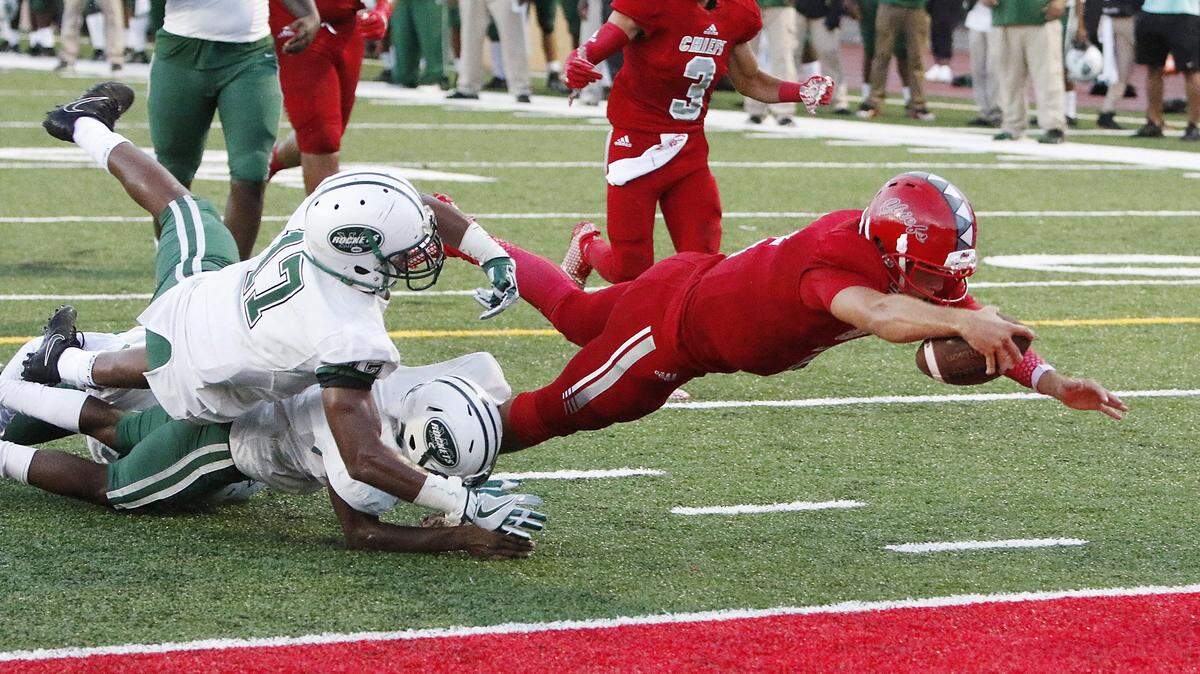Cardinal Gibbons (Fla.) quarterback Nik Scalzo dived for a touchdown against Miami Central on Aug. 25. Scalzo has committed to UK for the class of 2019.