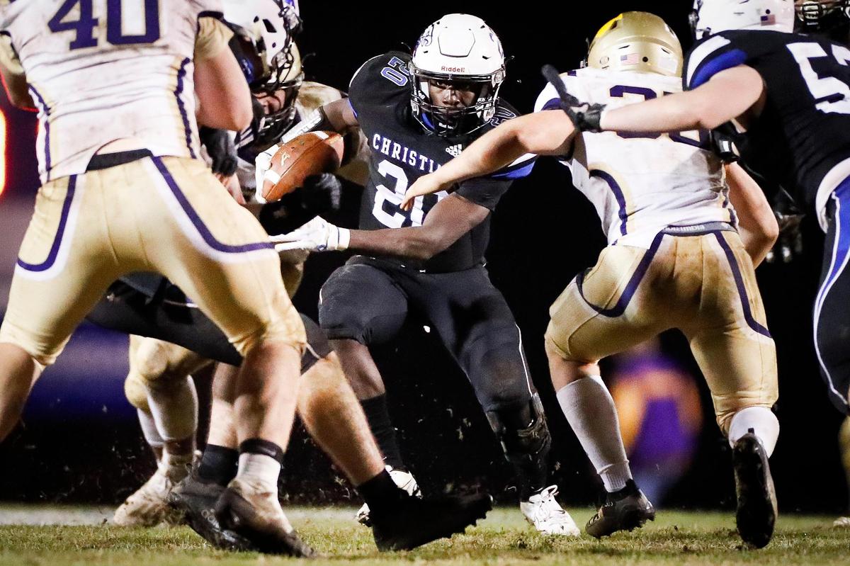 Lexington Christian’s Xavier Brown (20) weaved between Somerset defenders during the Class 2A district finals on Nov. 27, 2020.