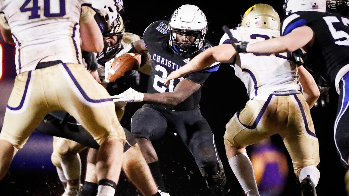 Lexington Christian’s Xavier Brown (20) weaved between Somerset defenders during the Class 2A district finals in Lexington last November. The Eagles and Briar Jumpers have faced each other for the district championship each of the last two years.