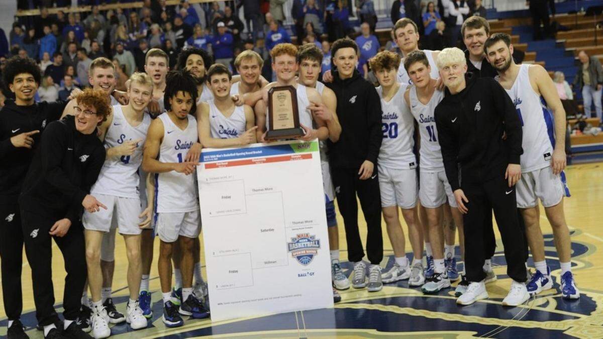 Thomas More’s players posed with their trophy for winning the Crestview Hills Quadrant of the men’s NAIA national tournament on Saturday. The Saints now advance to the NAIA round of 16 this week in Kansas City, Mo.
