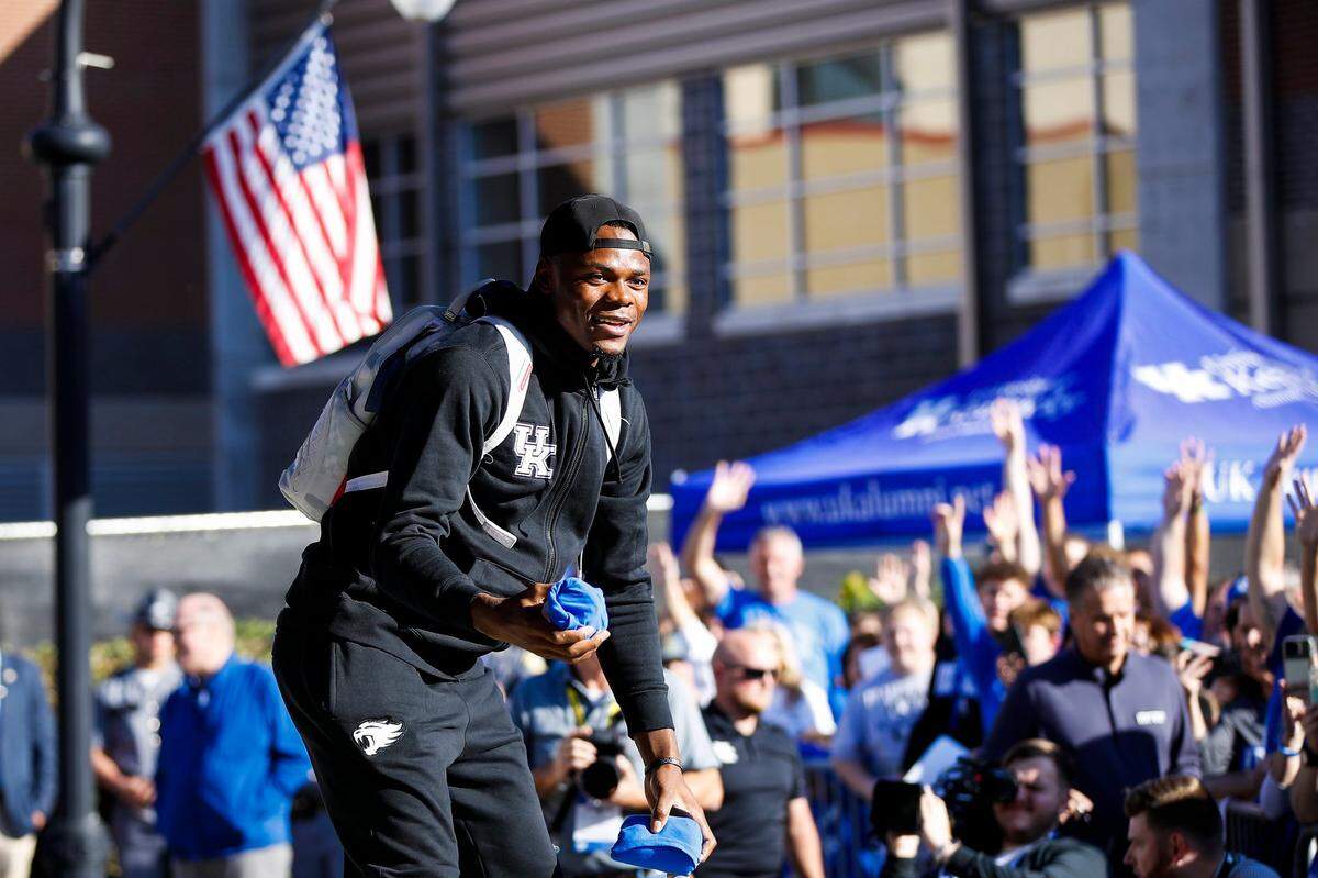 Kentucky basketball player Oscar Tshiebwe tosses T-shirts to the crowd gathered outside Appalachian Wireless Arena in Pikeville to greet the Wildcats before Saturday’s Blue-White Game.