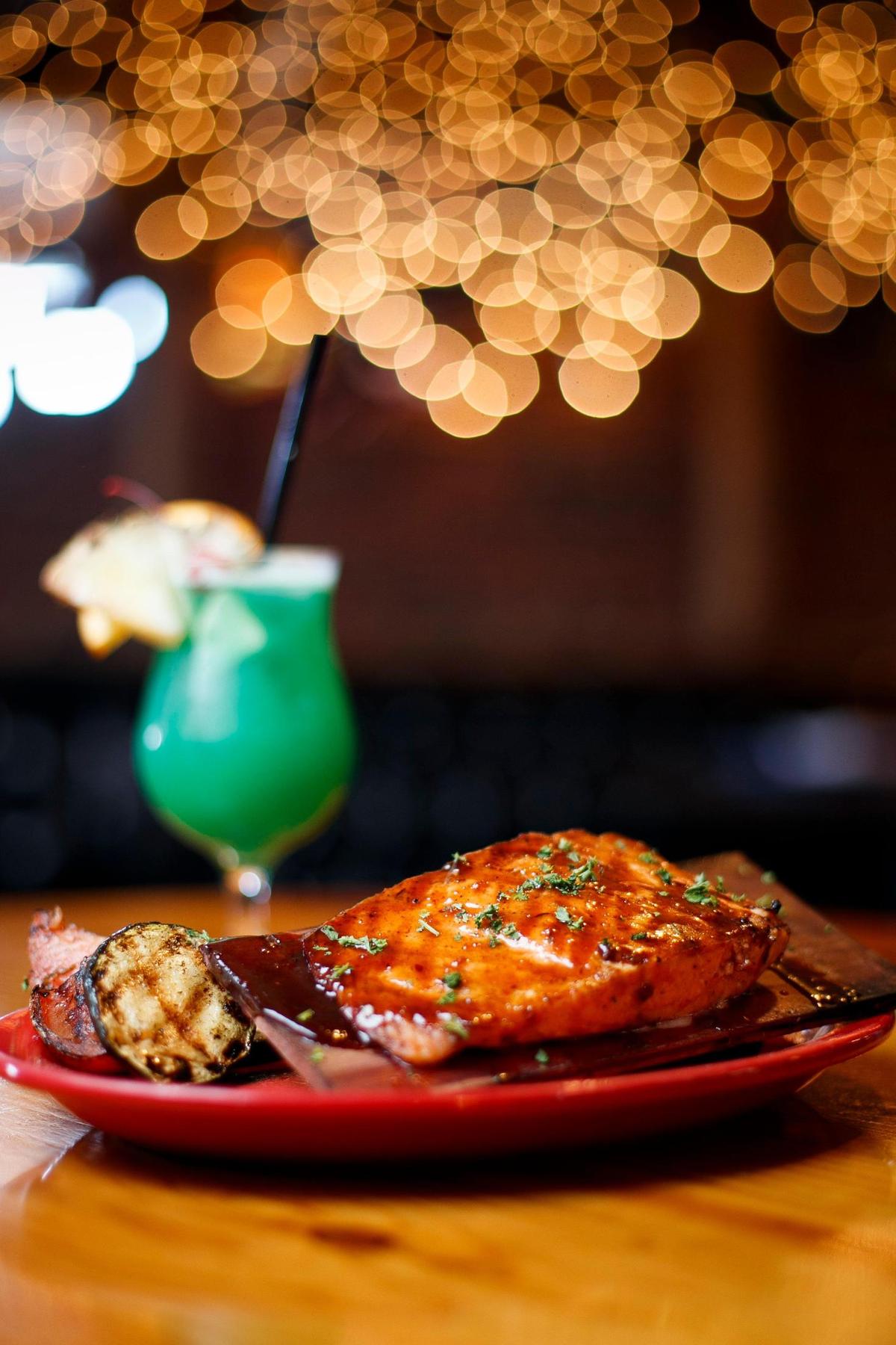 Cedar plank grilled salmon with jerk sauce served with grilled vegetables at The Ketch in Lexington, Ky., Friday, March 12, 2021.