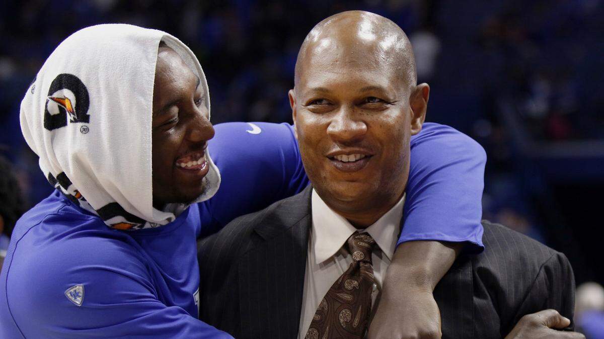 Former Kentucky Wildcats men’s basketball assistant Kenny Payne, right, was on the receiving end of a hug from then-UK big man Bam Adebayo after the Cats blew out Tennessee-Martin 111-76 early in the 2016-17 season. Payne, now an assistant with the NBA’s New York Knicks, is seen as the leading candidate to become the next head men’s hoops coach at his college alma mater, Louisville.