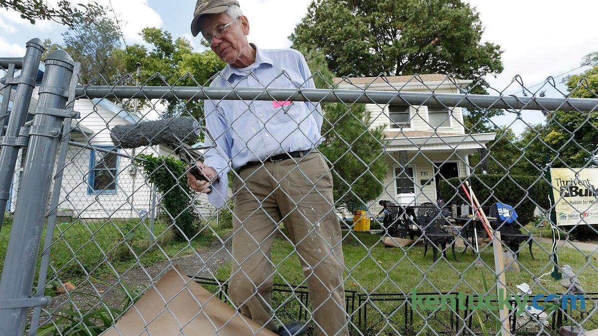 Bill Fortune painted fence on Dakota Street in Lexington, Ky., on Oct. 10, 2015. This is the third year Thrivent Financial has partnered with Habitat for Humanity to have a “Repairs Day” in Lexington. Photo by Pablo Alcala | Staff