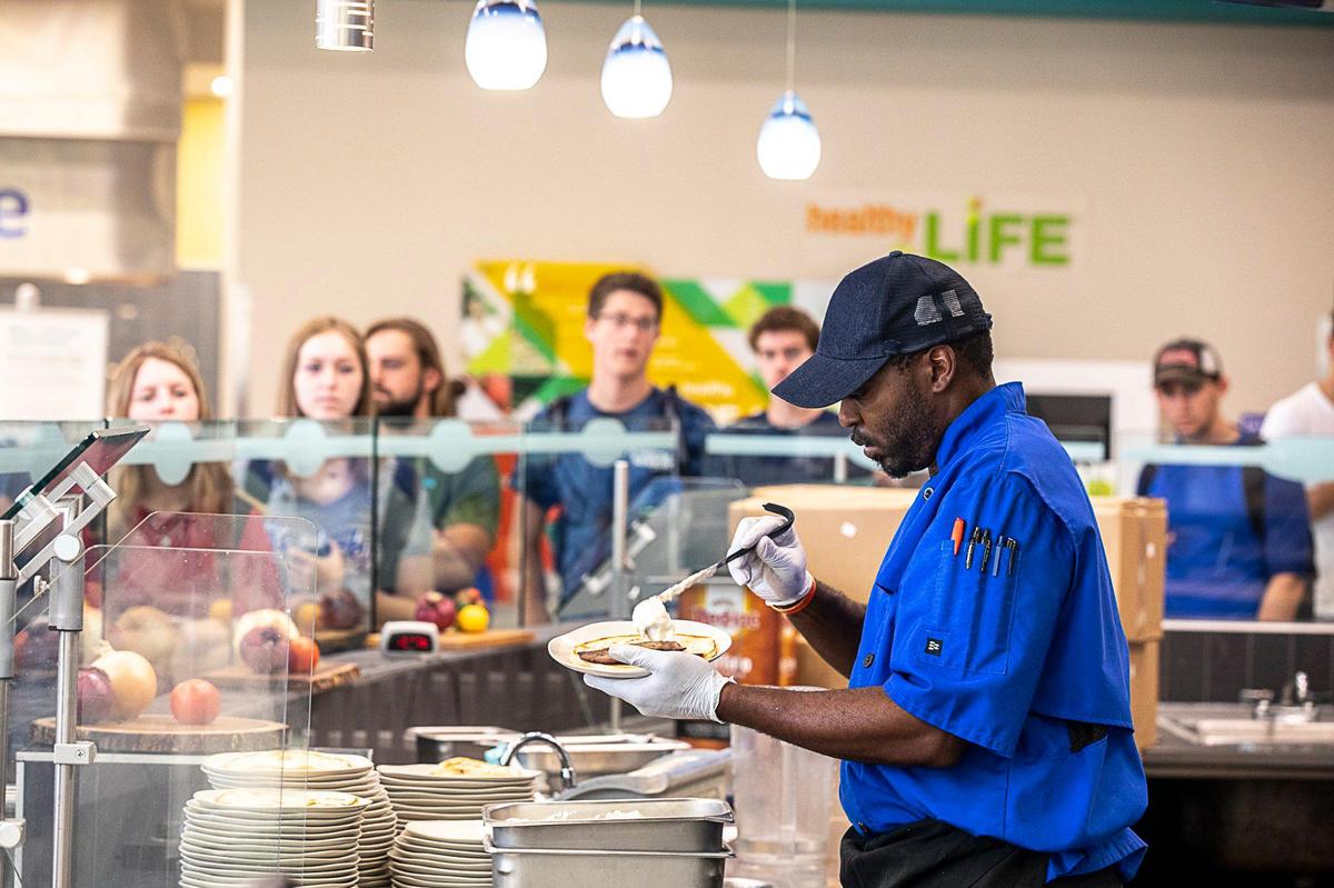 James Simpson prepares a classic gyro at the Athenian Grill’s location at The 90. Students began lining up before lunchtime to get the Greek dish.