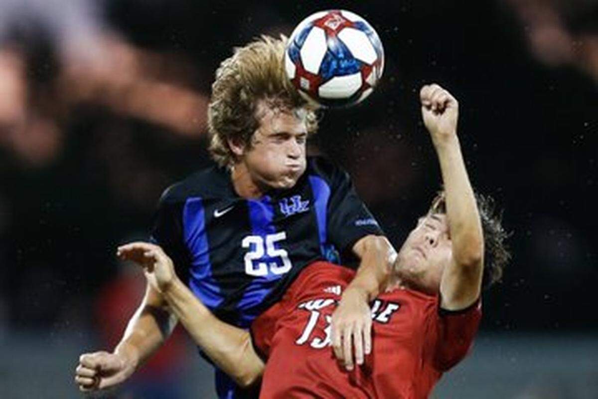 Kentucky’s Clay Holstad (25) battled with Louisville’s Bradley Sample during Tuesday night’s match at Lynn Stadium in Louisville.