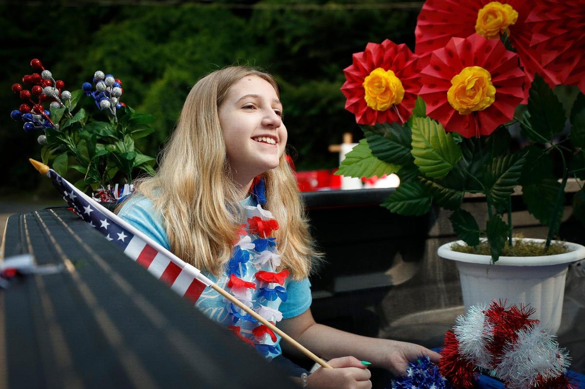 Felicity Blair, 11, of Cumberland, Ky., waits in the Highly Favored Flowers float during a Fourth of July parade in Lynch, Ky., Saturday, July 3, 2021.