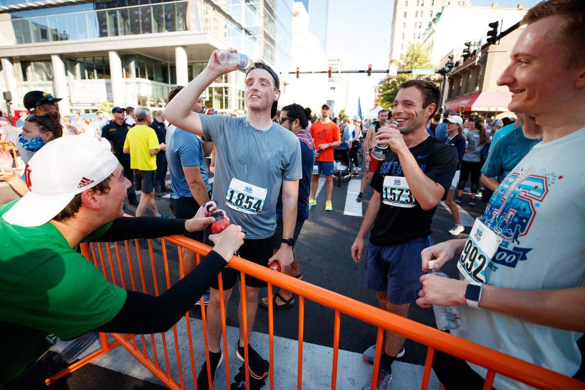 Herald-Leader sports reporter Cam Drummond (far left), speaks with Herald-Leader photographer Silas Walker (second left), Herald-Leader politics reporter Austin Horn (third left) and Herald-Leader breaking news editor Jeremy Chisenhall following Monday’s Bluegrass 10,000 in downtown Lexington. All four men ran the race, although Horn accidentally missed a turn on the course.