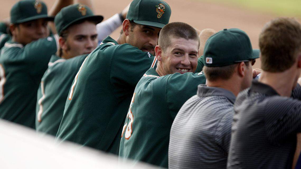 Greensboro third baseman J. T. Riddle, without hat, a former Kentucky Wildcat and native of Frankfort, came home to face the Lexington Legends on Tuesday.