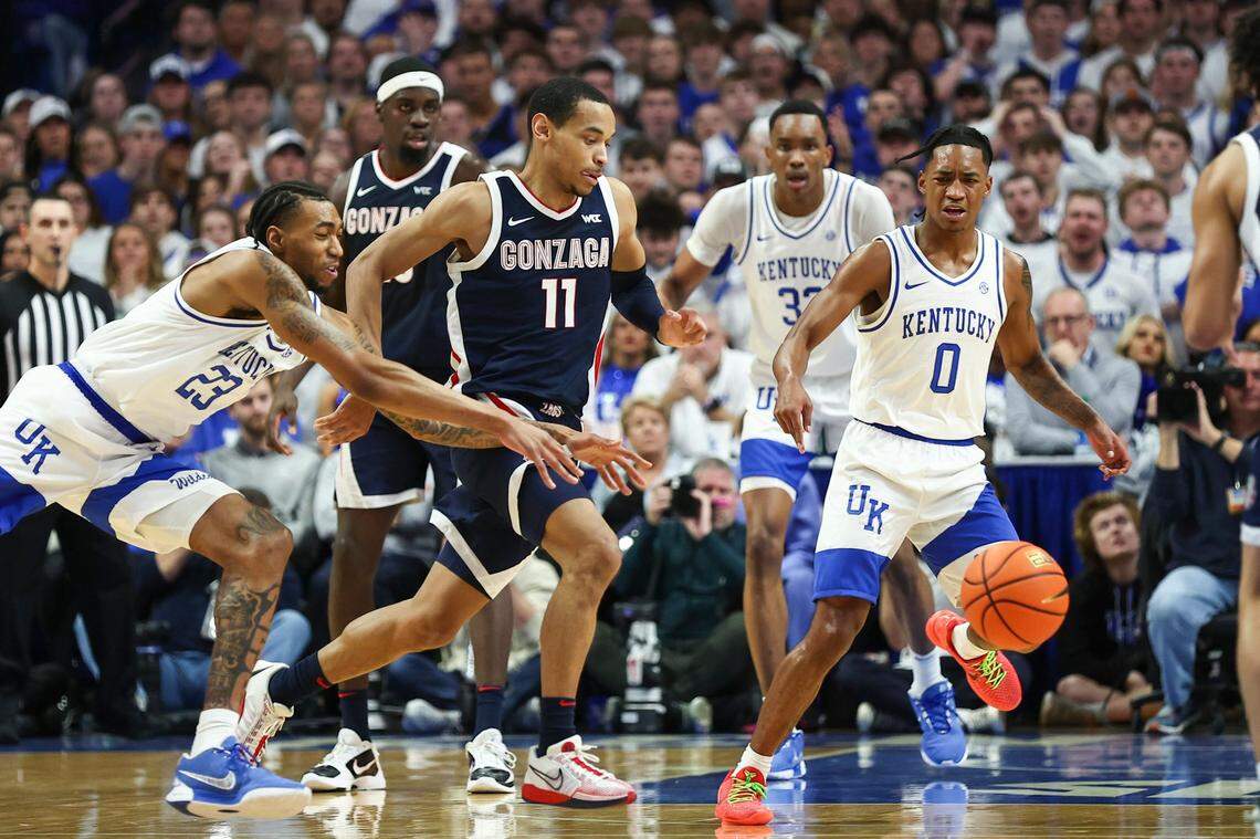Gonzaga guard Nolan Hickman (11) runs after a loose ball tipped by Kentucky guard Jordan Burks (23) during Saturday’s game at Rupp Arena.