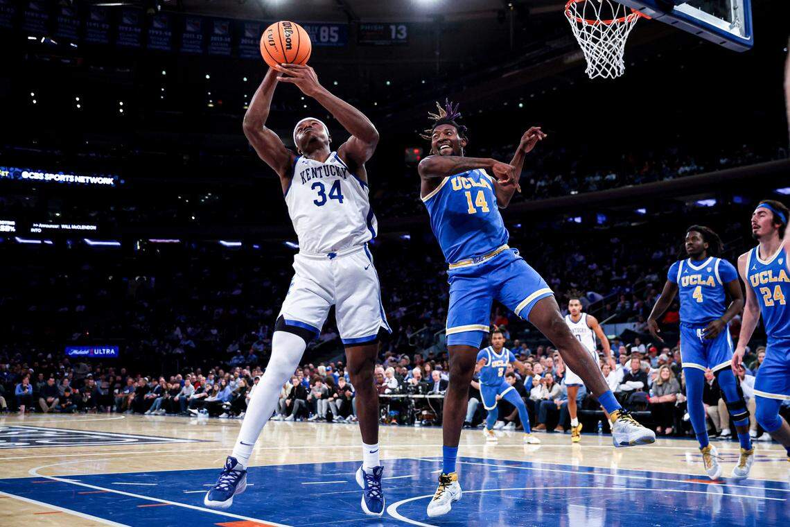 Kentucky forward Oscar Tshiebwe (34) grabs the ball away from UCLA forward Kenneth Nwuba (14) during the first half in the CBS Sports Classic on Saturday in New York.