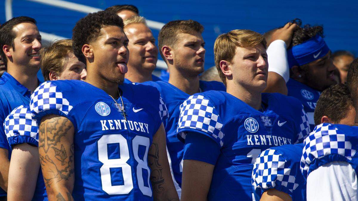Freshman tight end Keaton Upshaw (88) sticks his tongue out during the team photo portion of UK football media day at Kroger Field on Friday.