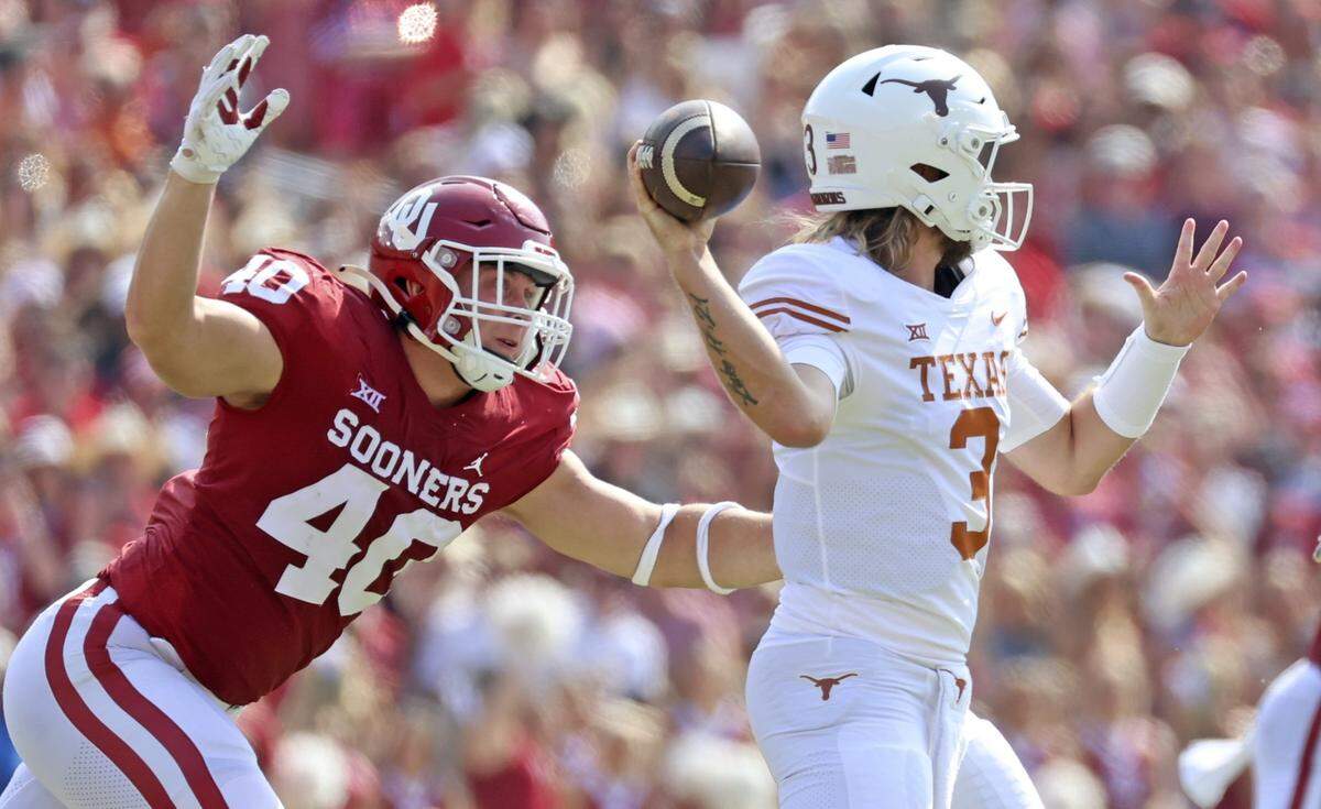 Oct 8, 2022; Dallas, Texas, USA;  Texas Longhorns quarterback Quinn Ewers (3) throws as Oklahoma Sooners defensive lineman Ethan Downs (40) chases during the first half at the Cotton Bowl. Mandatory Credit: Kevin Jairaj-USA TODAY Sports