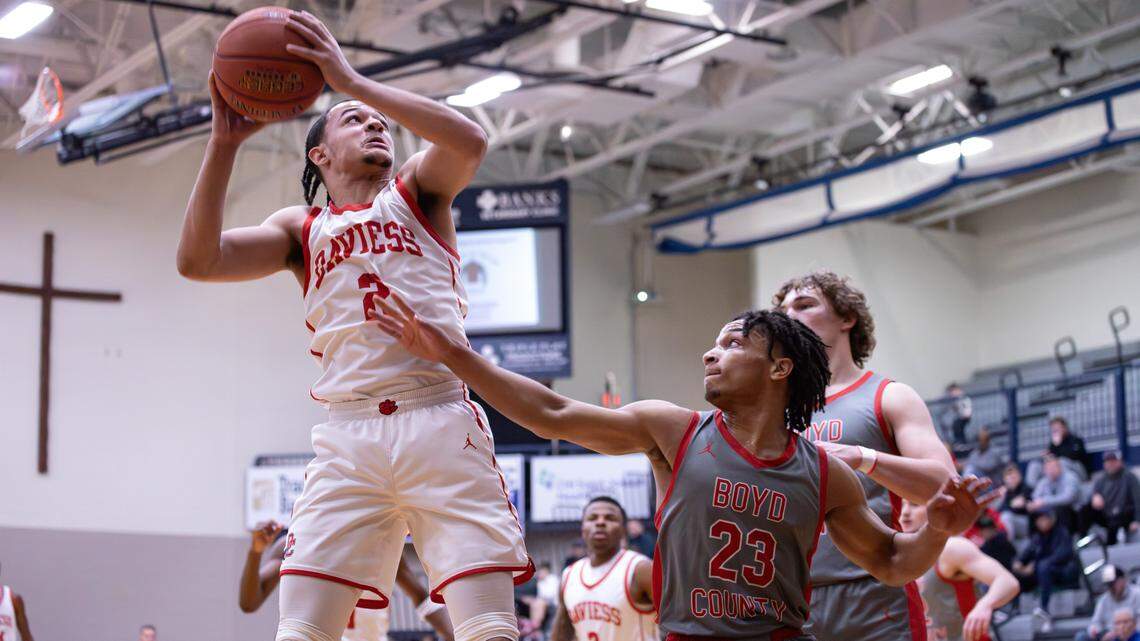 Daviess County's Michael Acton (2) makes the two-point shot over Boyd County's Malachi Payne (23) and Jacob Spurlock (2) during the White, Greer & Maggard Holiday Classic championship game on Dec. 30, 2025, in Lexington, Ky.