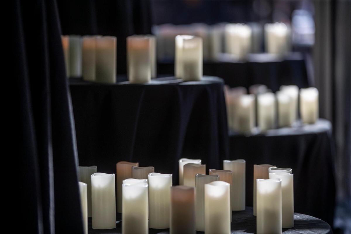 Candles in honor of COVID-19 victims are in the windows at the Pam Miller Downtown Arts Center in Lexington, Ky., on Friday, Nov. 20, 2020. Mayor Linda Gorton and several members of the faith community held a memorial in honor of the 106 people who have lost their lives to the coronavirus since the start of the pandemic.