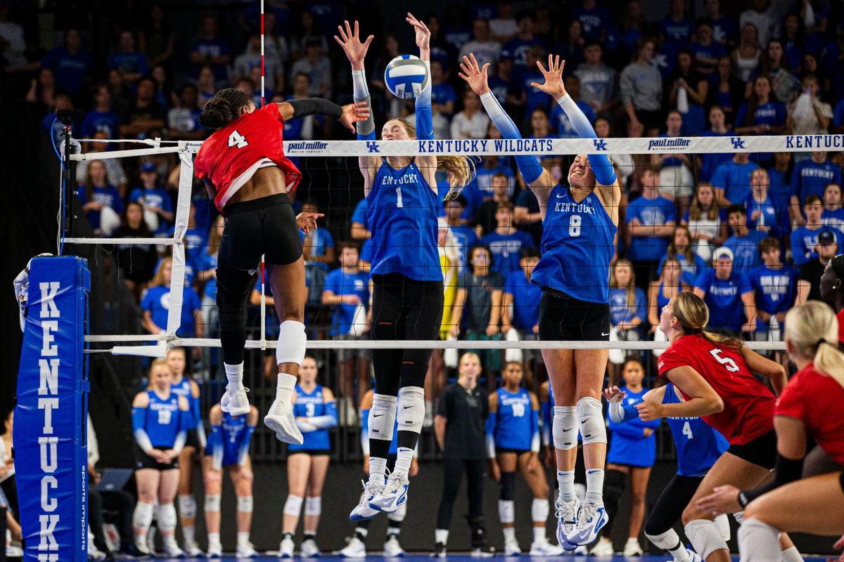 Kentucky’s Megan Wilson (1) and Brooke Bultema (8) battle Louisville’s Charitie Luper at the net on Wednesday night.