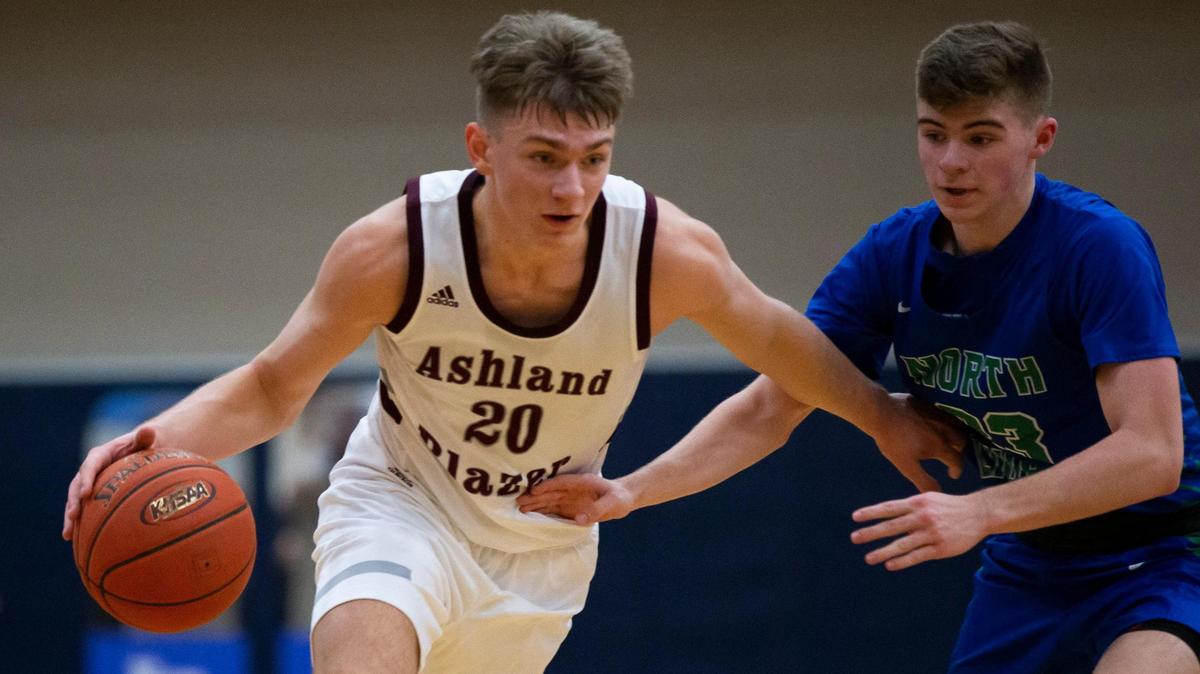 Ashland Blazer’s Cole Villers (20) drove toward the basket while being guarded by North Laurel’s Brody Brock (23) during the game at Lexington Catholic in Lexington, Ky., on Friday, March 5, 2021.