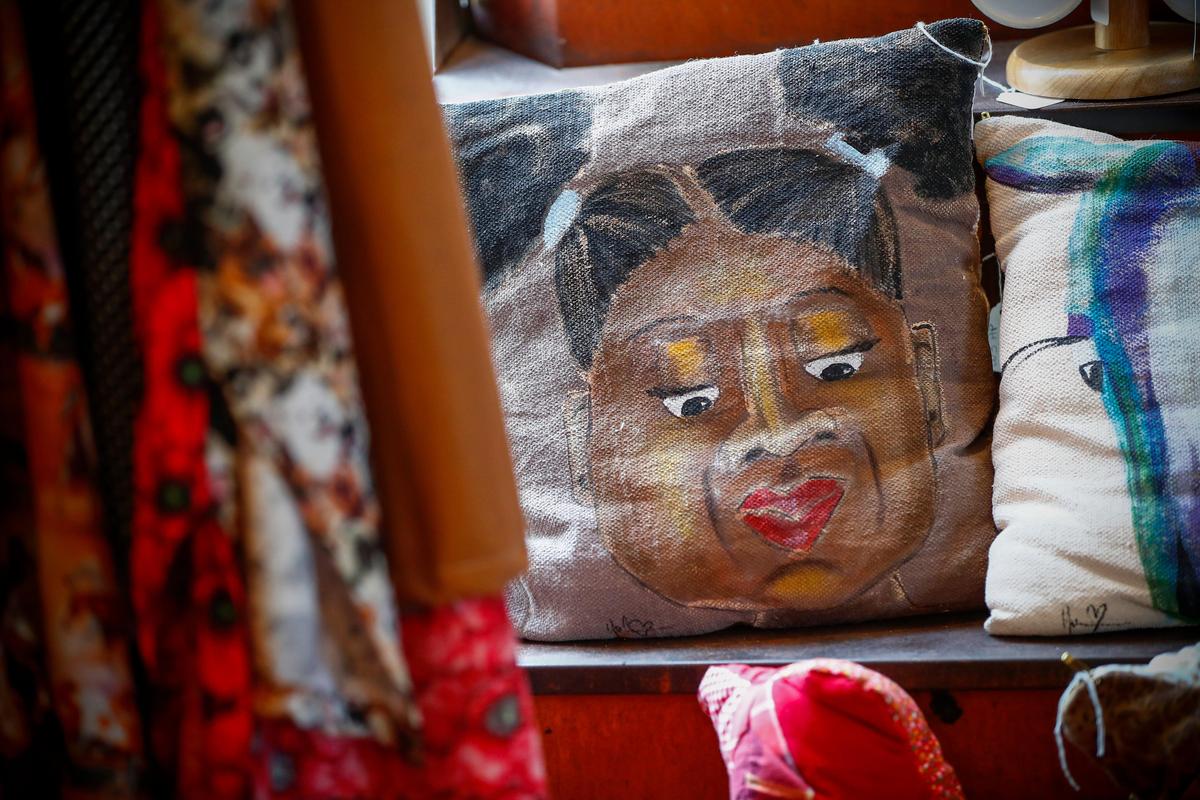 Pillows and other hand made items from Louisville based artist Yolantha Harris-Pace sit for sale at Wild Fig Books & Coffee in Lexington, Wednesday, July 31, 2019. Wild Fig Books & Coffee is attempting to draw in more business by offering programs such as comedy shows and film screenings.