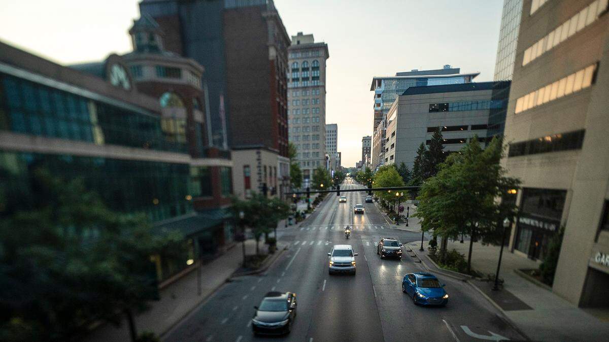 Vehicles drive along West Main Street in downtown Lexington, Ky.