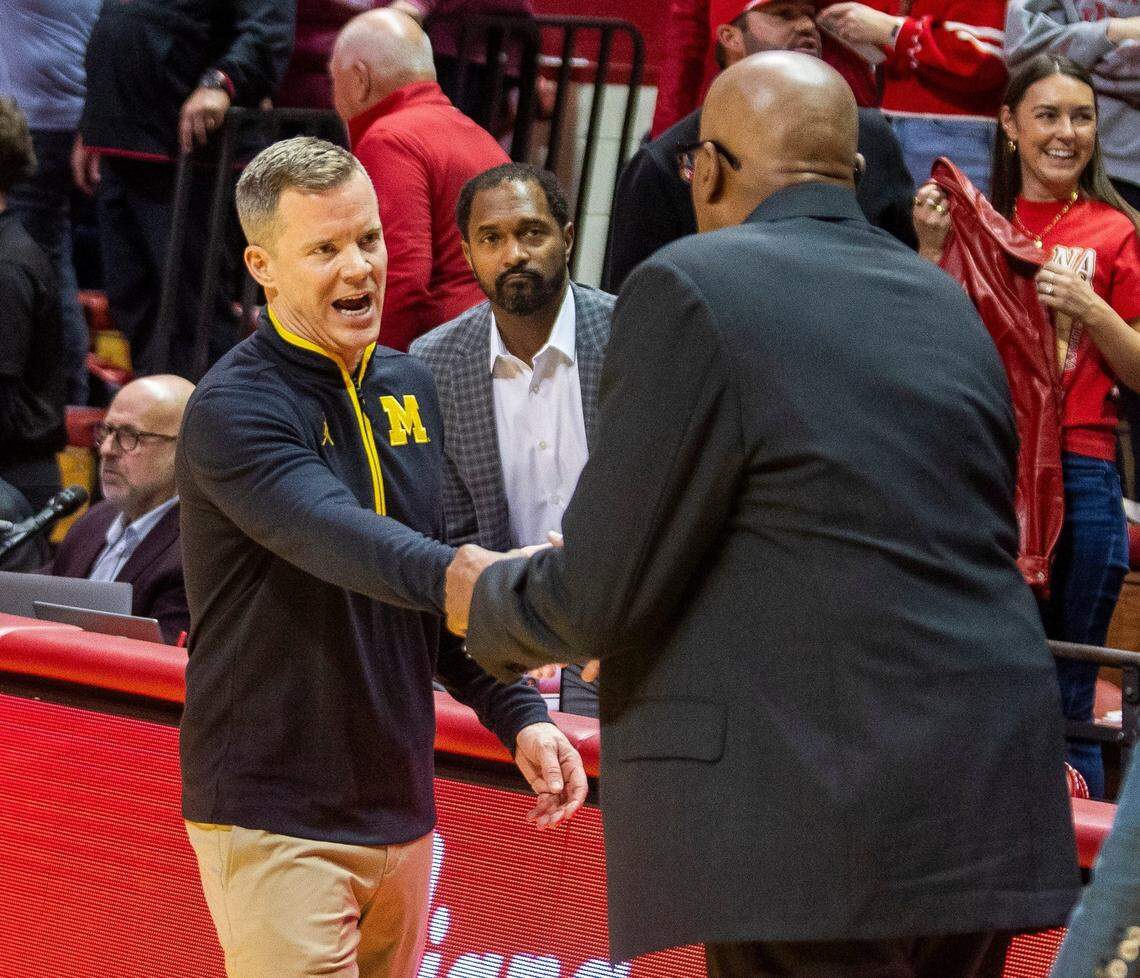Michigan coach Dusty May shook hands with departing Indiana coach Mike Woodson after the Wolverines beat the Hoosiers 70-67 last Saturday in Bloomington. May, a former IU manager, is being speculated upon as a potential replacement for Woodson.