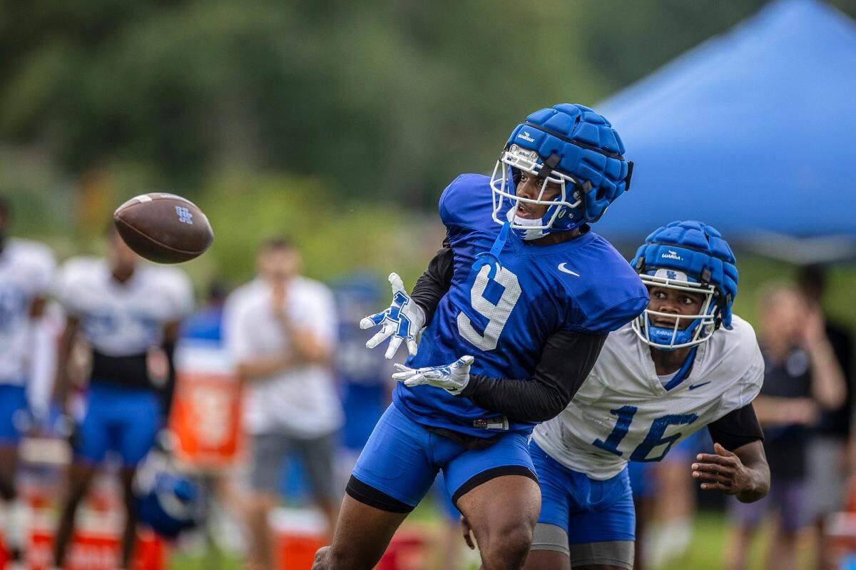 Tayvion Robinson reaches to catch a pass during Kentucky fan day and open practice at the Joe Craft Football Training Center practice fields on Aug. 6.