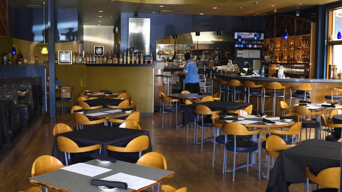 Azur restaurant decorates tables Friday to signify which can and can’t be used in an effort to maintain social distancing. The Beaumont restaurant was booked to capacity for Friday night dinner.