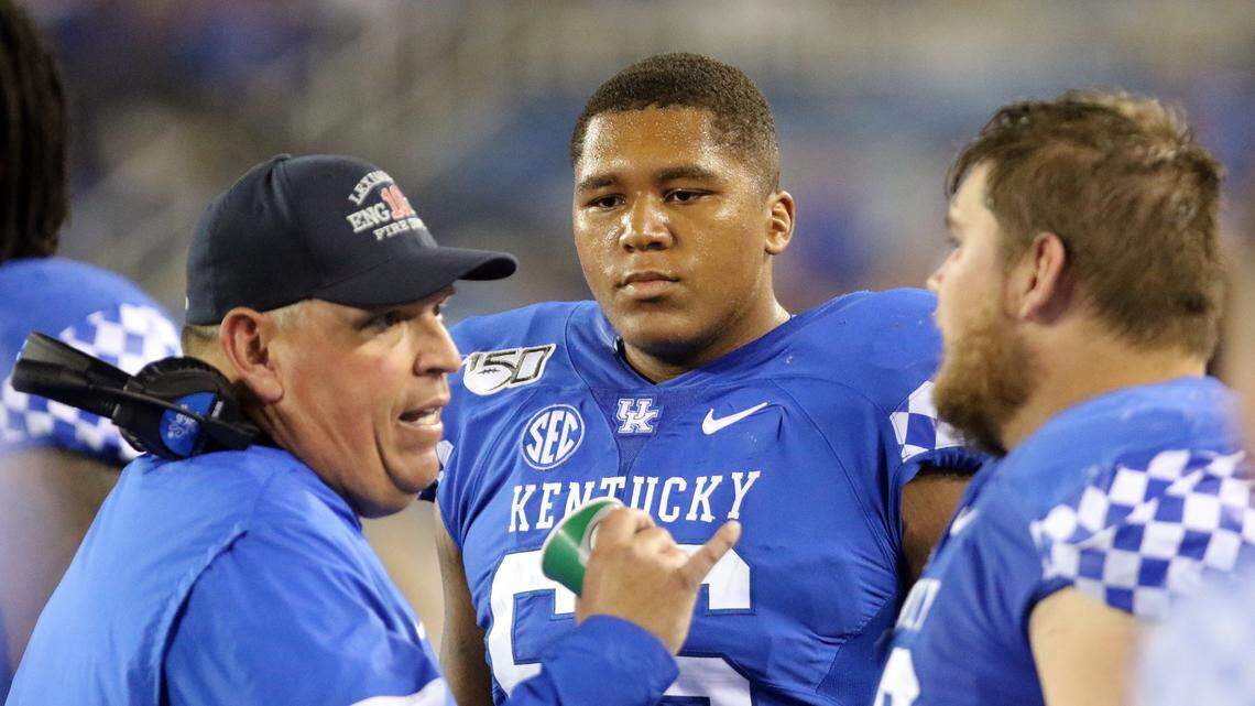 Kentucky left tackle Naasir Watkins, center, talked with offensive line coach John Schlarman, left, and center Drake Jackson on the sidelines during a game in 2019.