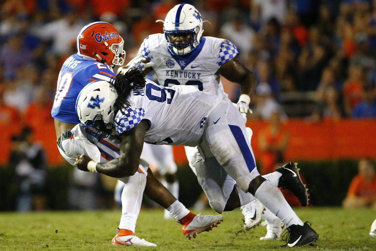 Kentucky defensive tackle Adrian Middleton (99) tackled Florida running back Malik Davis (20) during UK’s 27-16 victory at The Swamp earlier this season. Middleton, a senior from South Warren High School, has made 31 consecutive starts for Kentucky.