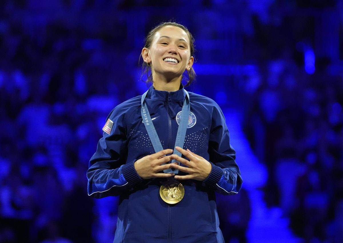 Paul Laurence Dunbar High School graduate Lee Kiefer was on the top rung of the podium after winning the Olympics gold medal in women’s foil fencing Sunday in Paris.
