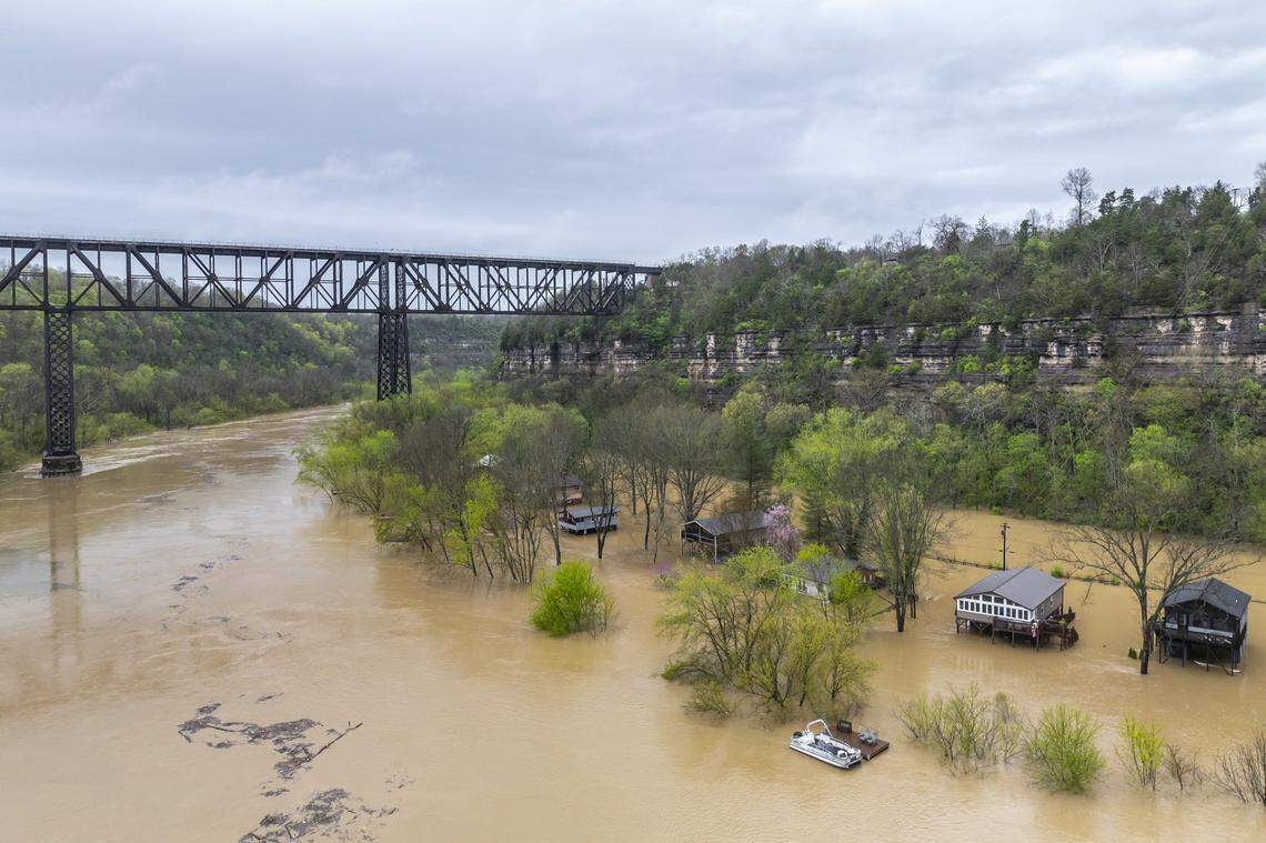 The Kentucky River surrounds homes on Dix Drive near High Bridge in Jessamine County on Saturday, April 5, 2025.