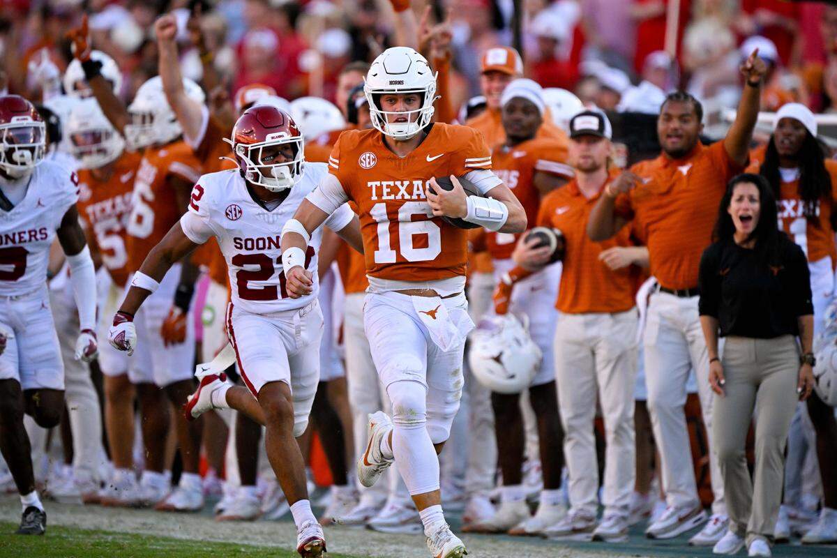 Oct 11, 2025; Dallas, Texas, USA; Texas Longhorns quarterback Arch Manning (16) runs for a first down against the Oklahoma Sooners during the second half at the Cotton Bowl. Mandatory Credit: Jerome Miron-Imagn Images