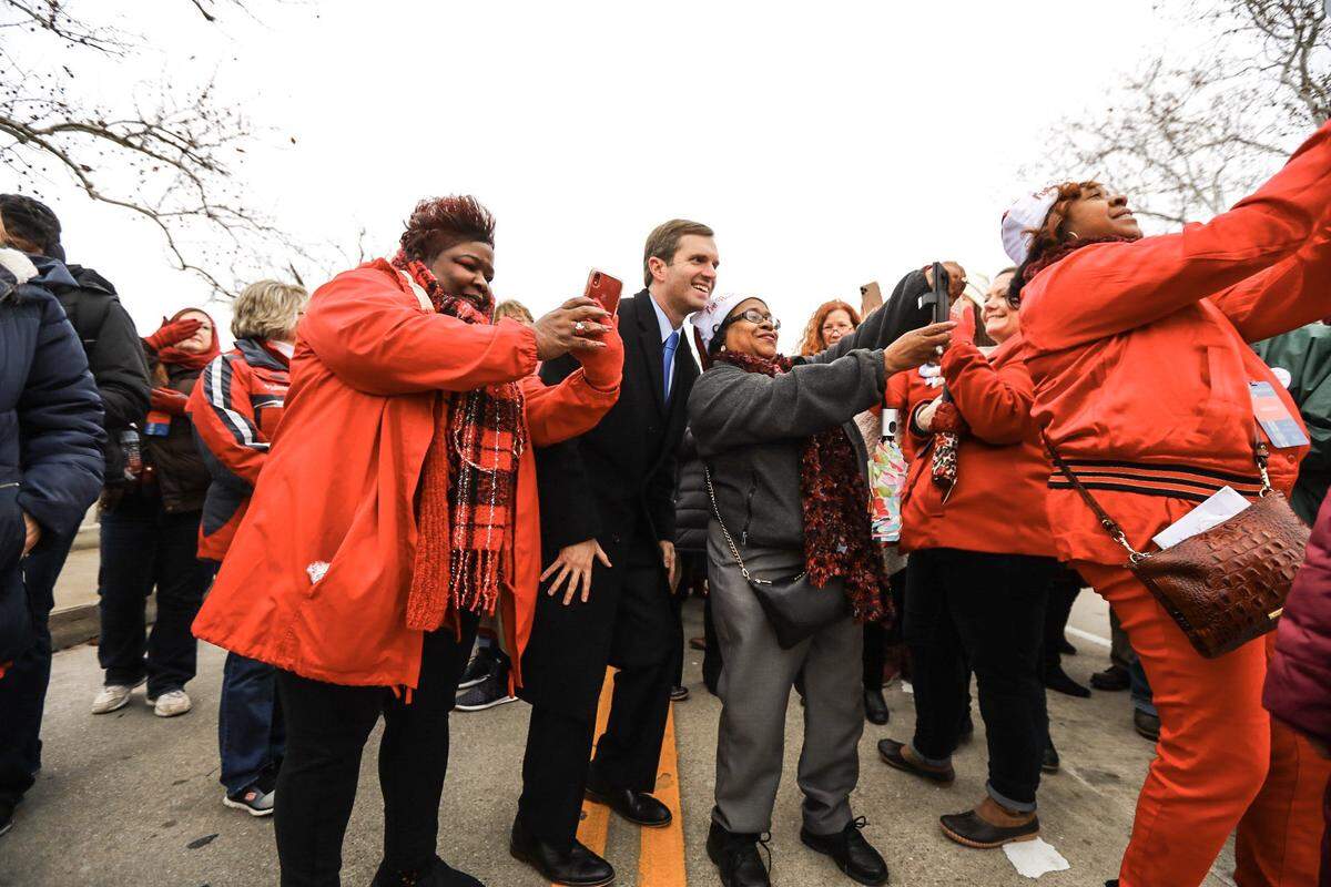 Gov. Andy Beshear takes selfies with supporters as the Inaugural Parade prepares to start in Frankfort, Ky., on Dec. 10, 2019.