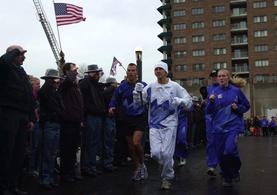 Dr. Ralph Miller, Mayor Pam Miller’s husband, carried the torch into the Farmers Market during the Olympic Torch Run through Lexington on it’s way to the winter games in Utah, Lexington, KY, Monday, December 17, 2001.