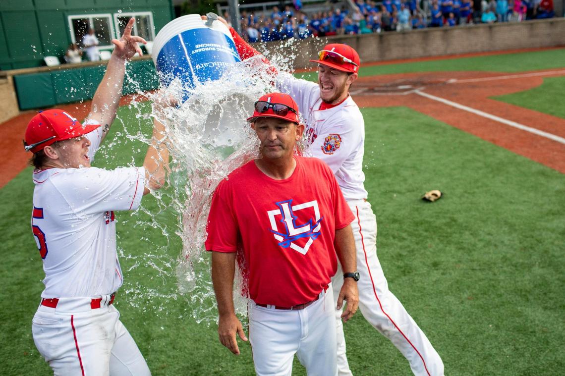 Lafayette Generals head coach Chris Langston is doused with water from a cooler after his team defeated Madison Central 8-1 during the KHSAA region finals at Lexington Catholic High School in Lexington, Ky., Monday, June 7, 2021.