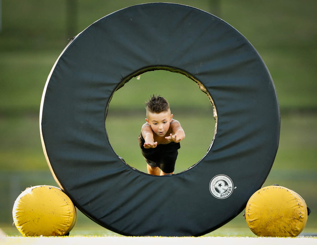A participant dives through an obstacle at Somerset Youth Football League camp at Williams Clark Football Field in Somerset, Ky., Saturday, July 11, 2020.