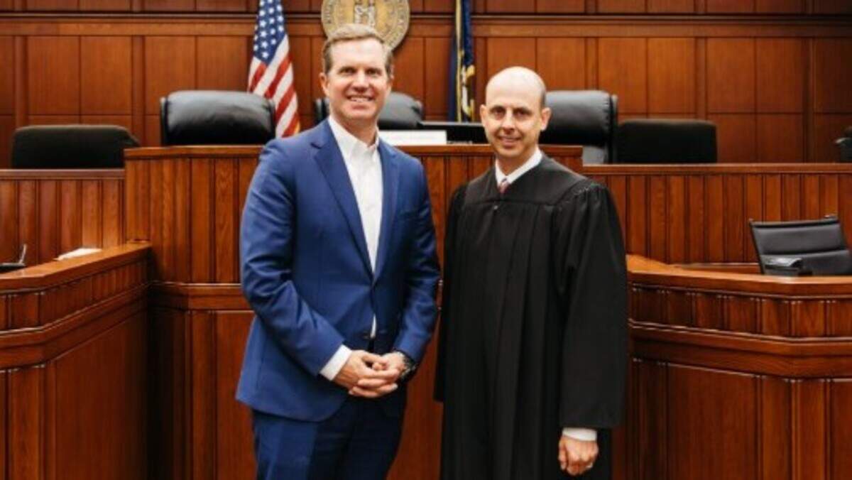 Gov. Andy Beshear, left, stands next to Court of Appeals Judge Will Moynahan, right, during Moynahan’s swearing in ceremony.
