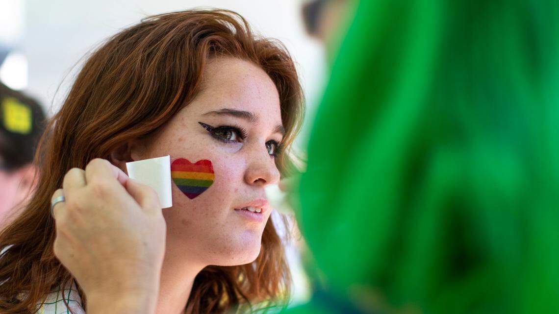 Attendees receive temporary, decorative tattoos during the annual Lexington Pride Festival in front of the Robert Stephens Courthouse in Lexington, Ky., Saturday, June 25, 2022.
