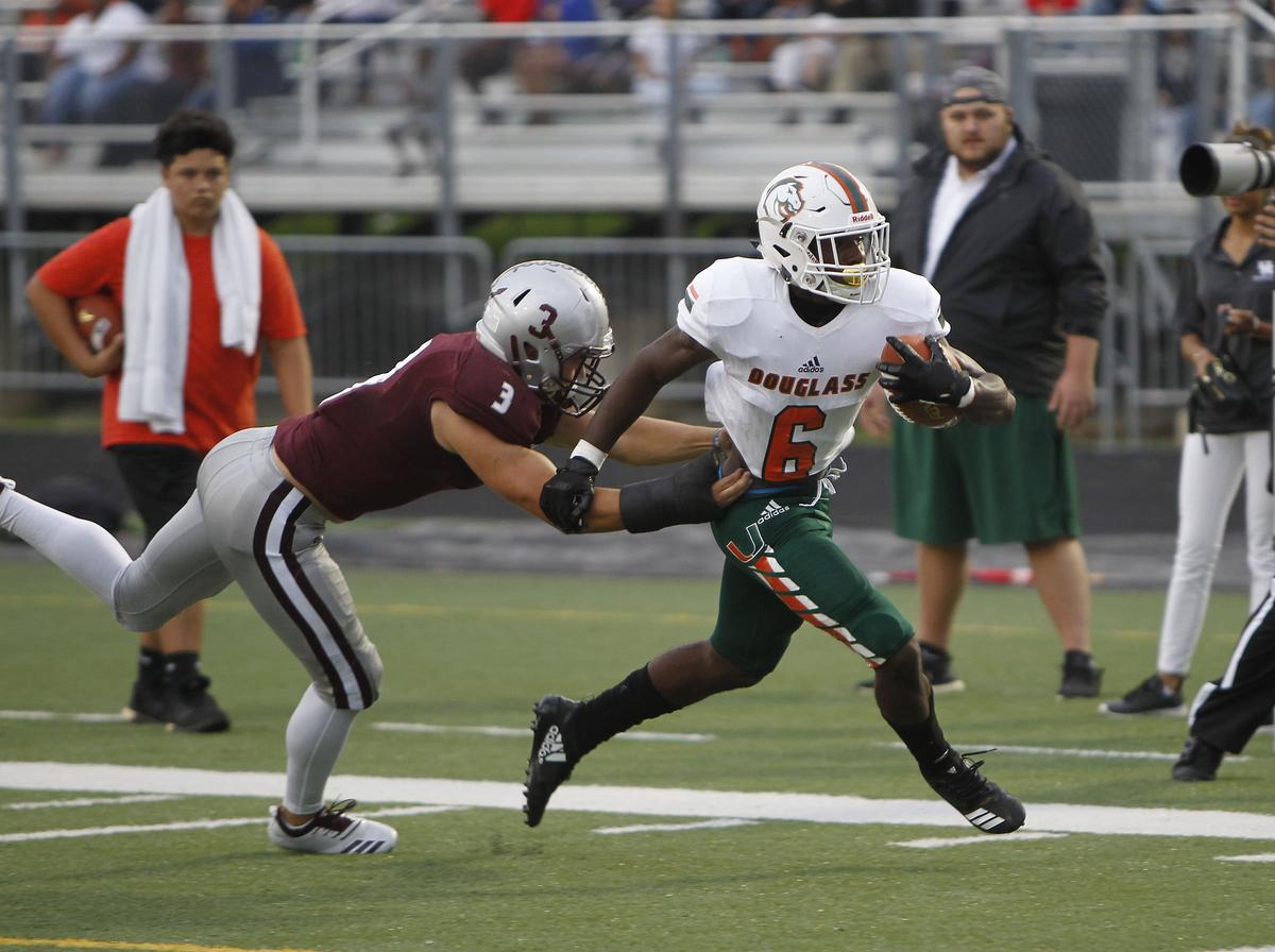 Frederick Douglass’ Damarco Fishback broke a tackle attempt by Tates Creek’s J.D. Hawkins on Friday.