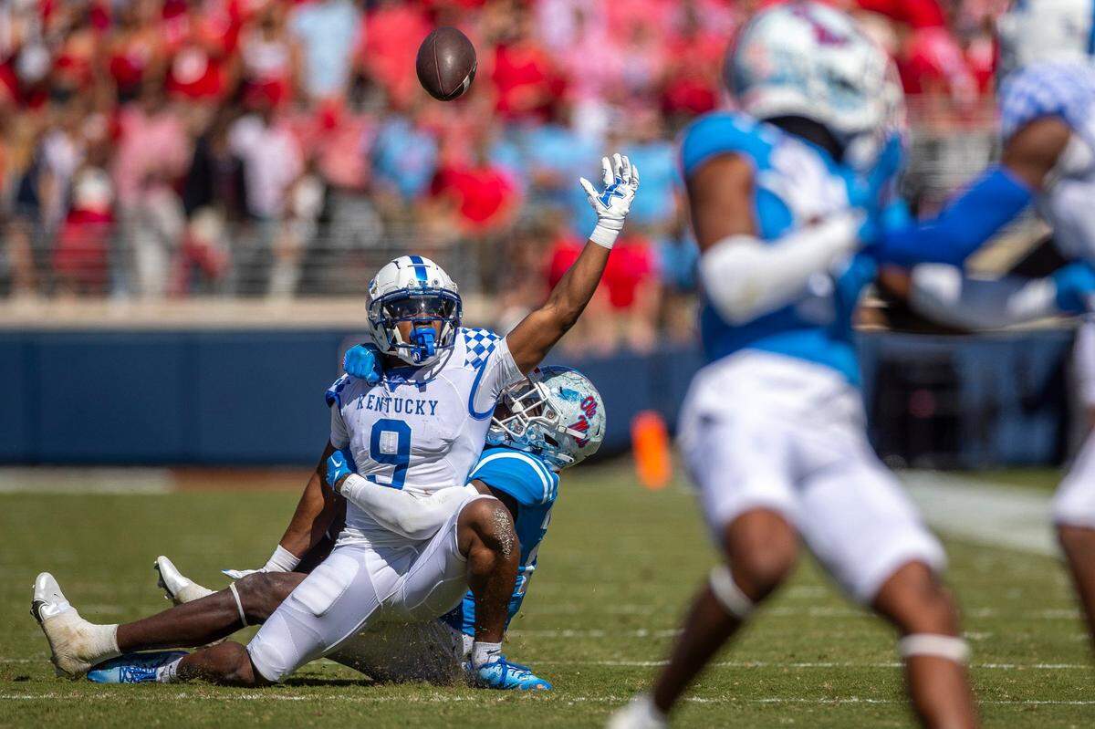 Kentucky wide receiver Tayvion Robinson (9) is unable to hold onto the ball as Mississippi safety AJ Finley wraps him up during Saturday’s game.
