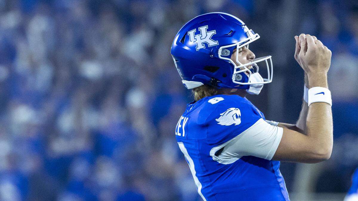 Kentucky quarterback Cutter Boley celebrates after a second-quarter touchdown pass to running back Jason Patterson during Saturday’s game against Florida at Kroger Field.