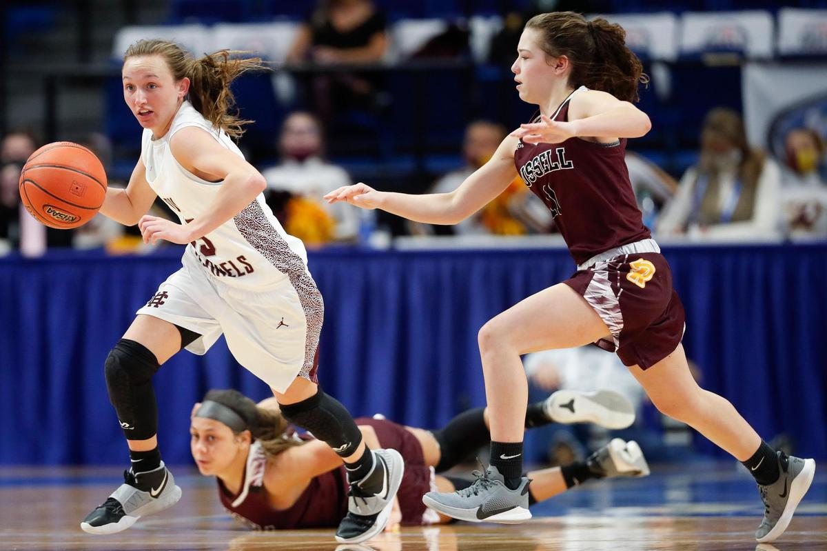 Henderson County’s Sadie Wurth (15) dribbles past Russell’s Shaelyn Steele (10) and Bella Quinn (11) during Friday night’s game.