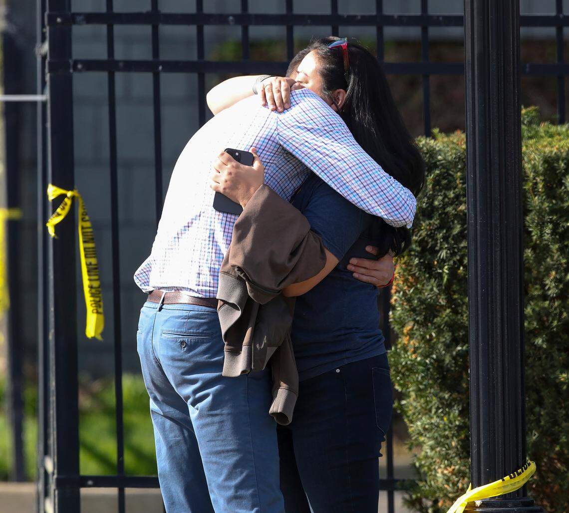 Two people embrace outside of a building where a shooting took place in Louisville, Ky., Monday, April 10, 2023.
