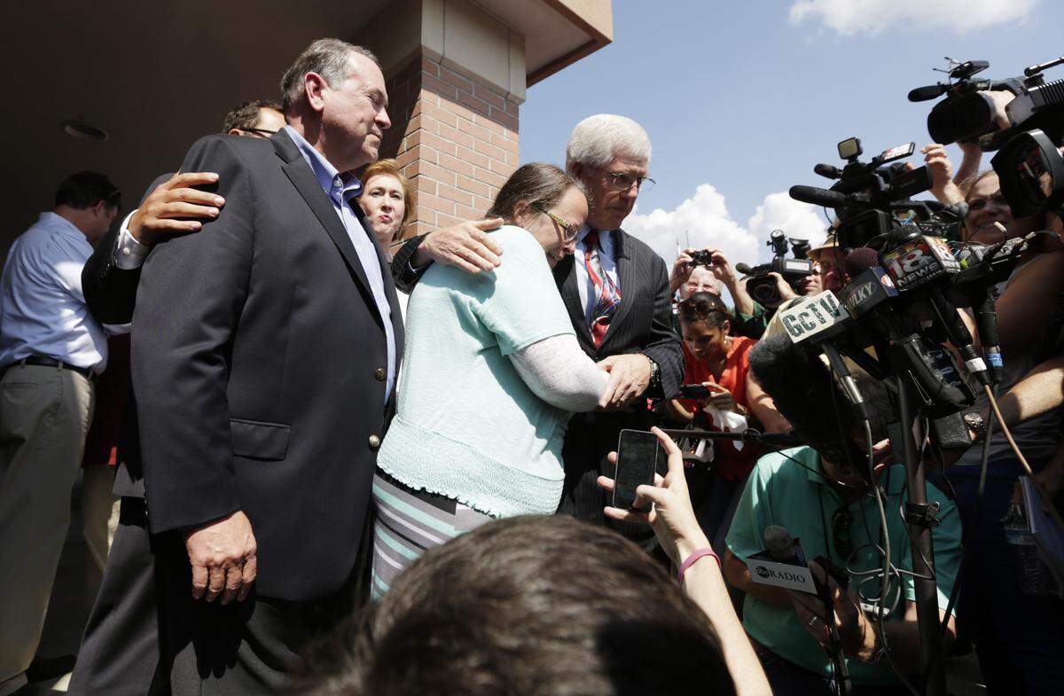 Kim Davis was held by her lawyer, Mat Staver, as they appeared before the media with Mike Huckabee outside the Carter County Detention Center in Grayson on Sept. 8, 2015.