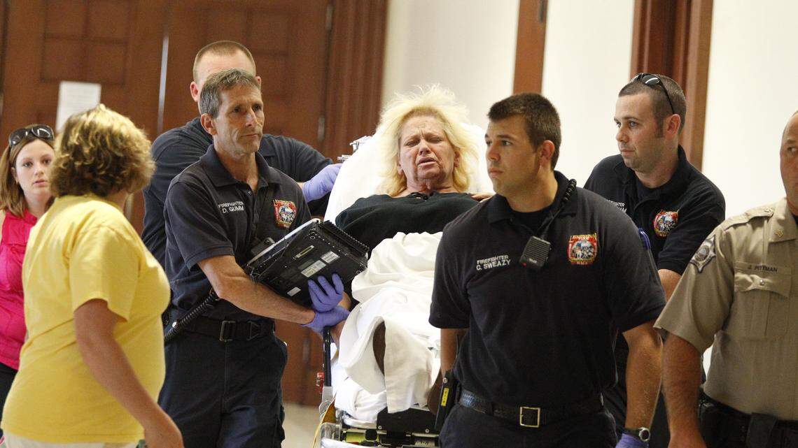 Lexington firefighters transported Cheryl G. Christopher from the courtroom after she suffered an apparent seizure during her preliminary hearing in Fayette District Court on Thursday.